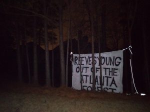Banner in treeline that says "REEVES YOUNG OUT OF THE ATLANTA FOREST"