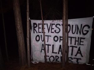 Banner in treeline that says "REEVES YOUNG OUT OF THE ATLANTA FOREST"