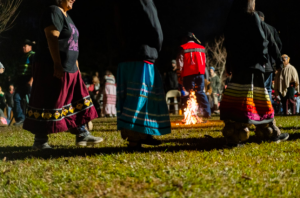 Women of the Muscogee (Creek) communities in Oklahoma dance during the cultural activities in the South River Forest on Nov. 27. Photo credit: Jesse Pratt López / The Mainline, 2021.