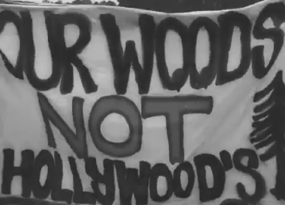 Banner Reading "Our Woods Not Hollywoods"